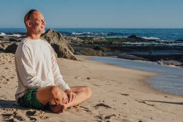 Man on beach looking content